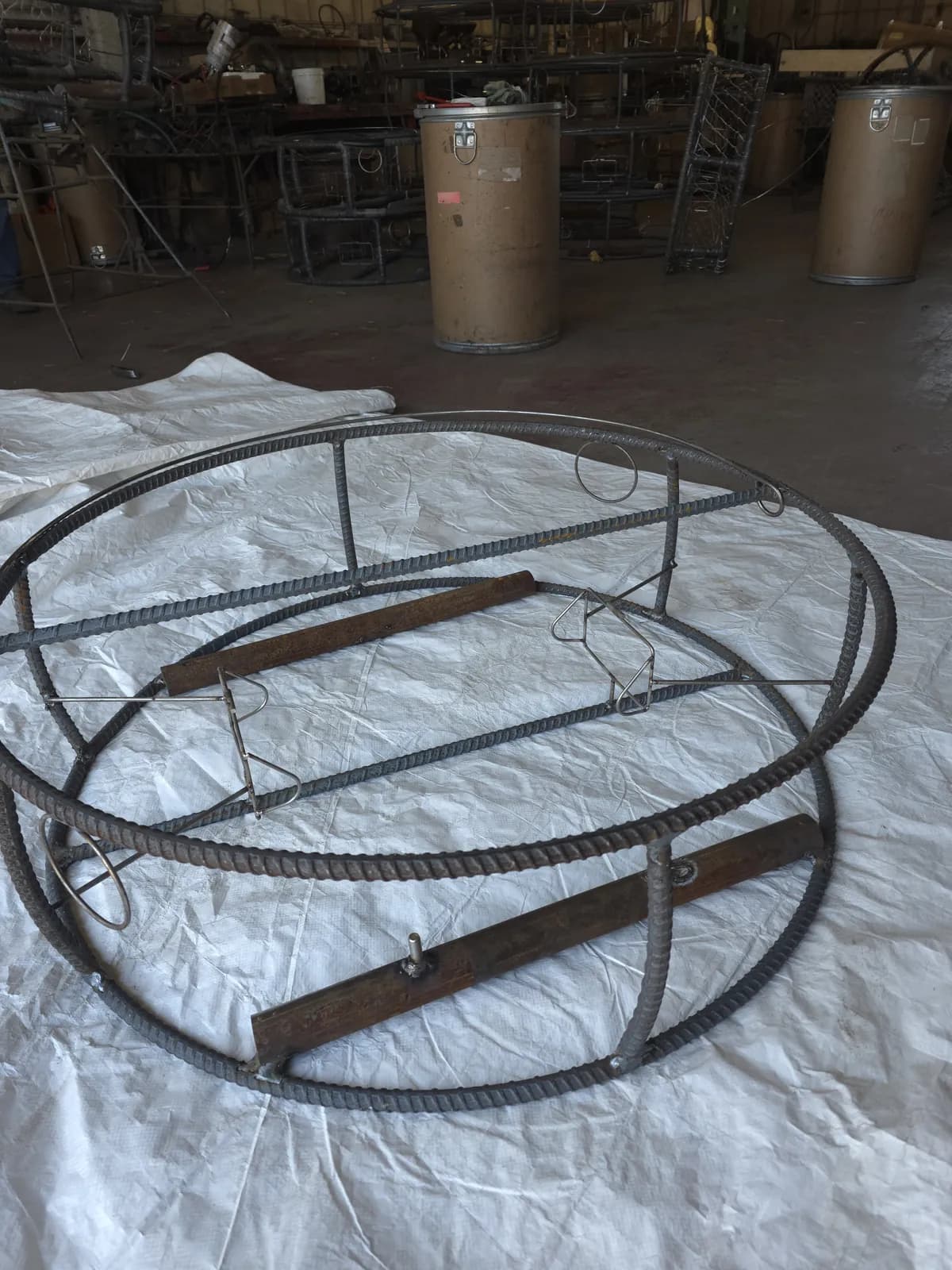 Bare CCP trap before wire and wrap: rebar rings, stanchions, crossbars, stainless tunnel frames and two weight bars