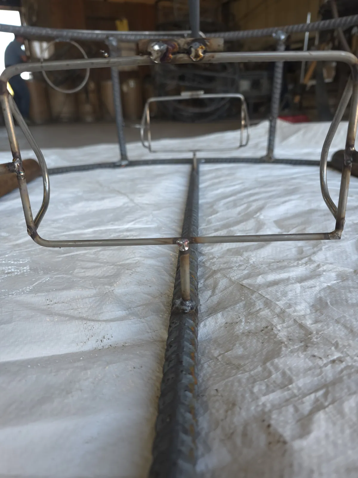 Bare stainless tunnel frame and trigger block welded into a CCP trap before wire is knitted on