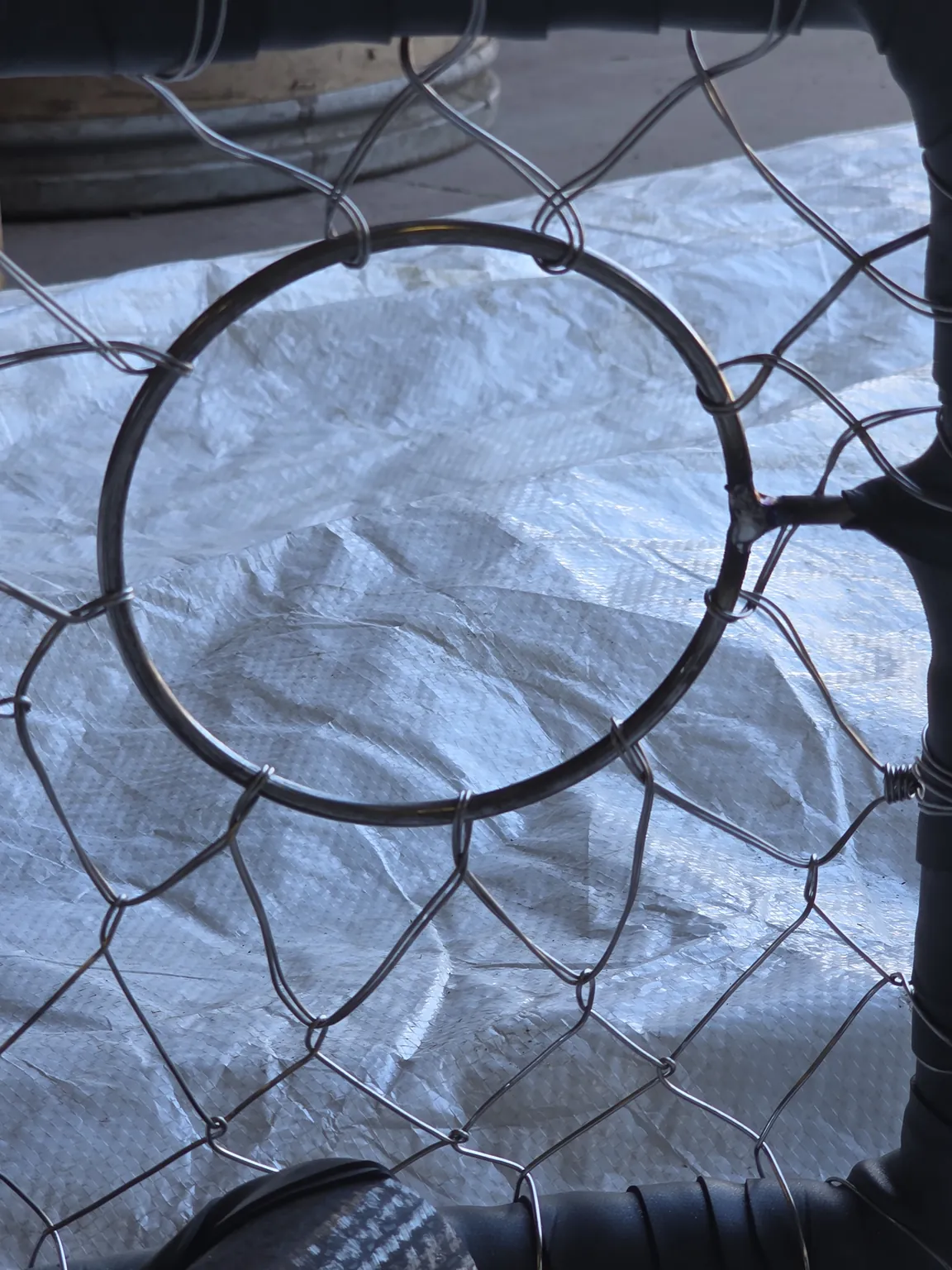 Escape ring on a rubber-wrapped CCP pot, welded to its post and knitted into the side wire