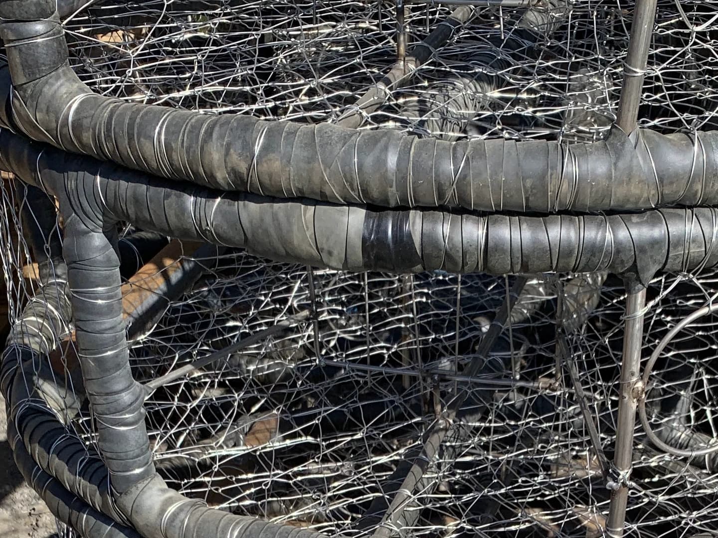 Overlapping wrap strips and securing wire around the curved upper ring of a CCP pot