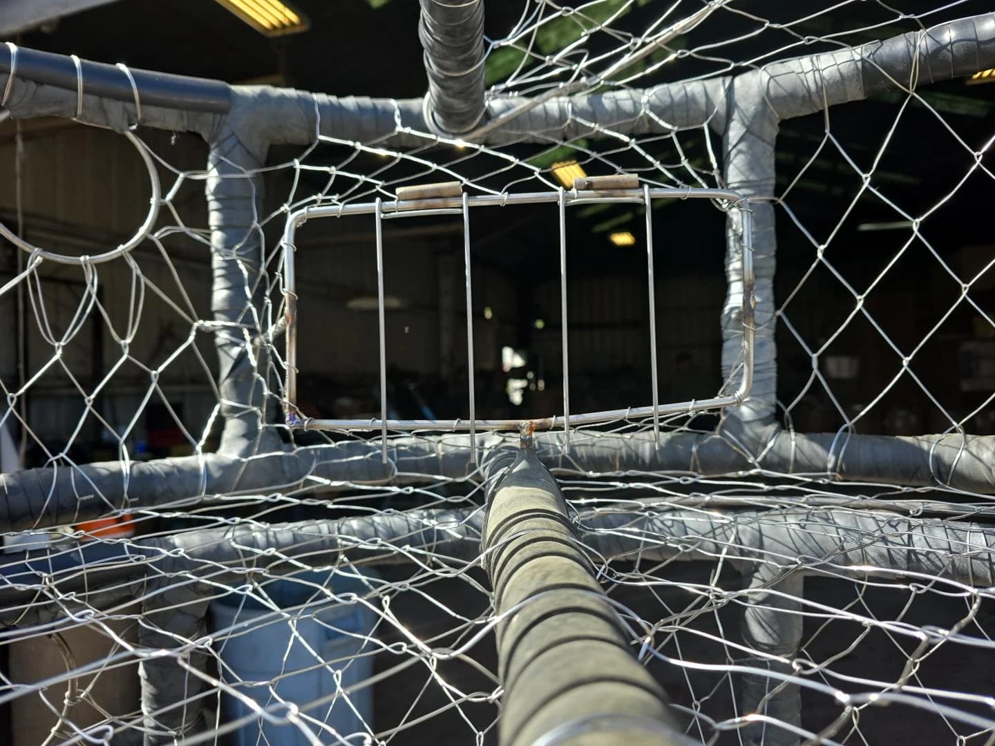 Standard wire tunnel viewed from inside the pot, showing the rectangular opening and metal triggers